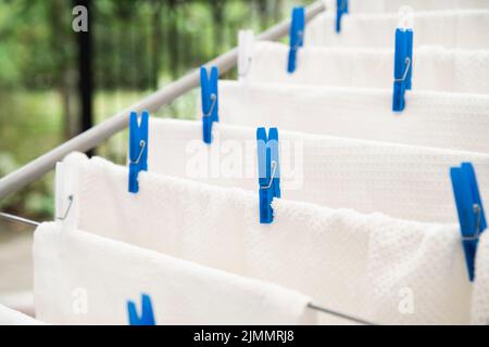 White towels drying clotheshorse Stock Photo