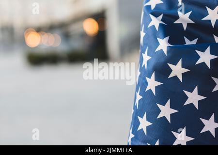 Crop american flag with wrapped person Stock Photo