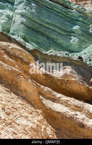 Turquoise colored rock layer Los Azulejos De Veneguera, volcanic rock steeped in sodium iron silicate, at Mogan. Gran Canaria Stock Photo