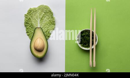 Flat lay avocado with bowl greens chopsticks Stock Photo