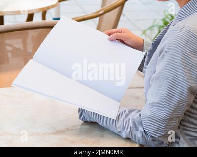 Close up woman reading mock up magazine Stock Photo