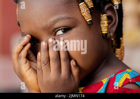 Close up african girl covering her face Stock Photo
