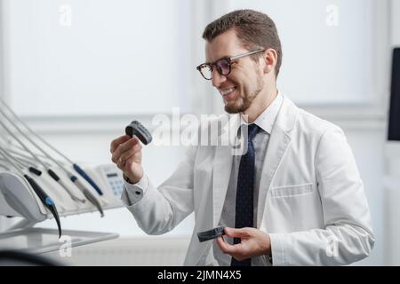 Dentist looking at photopolymer jaw printed on a 3d printer. Stock Photo