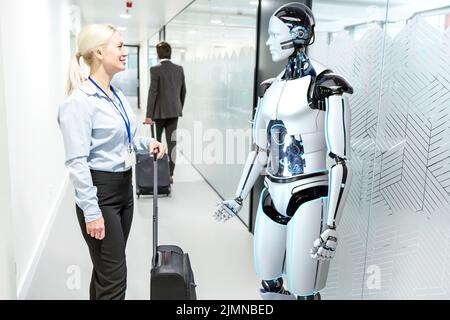 Humanoid robot assists company visitors Stock Photo