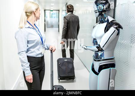 Humanoid robot assists company visitors Stock Photo