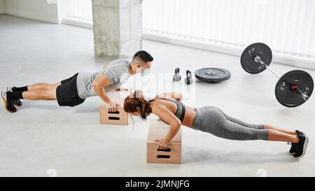 slim mature woman doing exercises on yoga mat isolated on white background  Stock Photo - Alamy