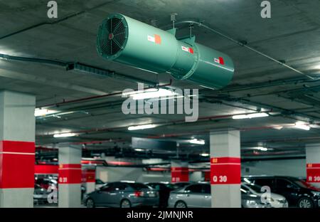 Jet fan at underground parking area. Ventilation fan in the parking lot. Air flow system. Ventilation system in underground car parking lot Stock Photo