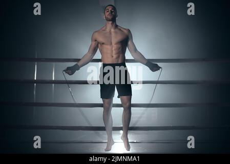 Boxer jumping rope in boxing ring. Stock Photo