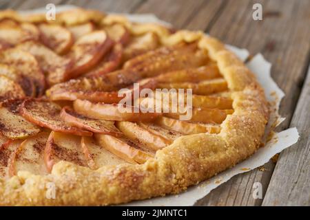 Apple pie, galette with a fruits, sweet pastries on old wooden rustic table, side view Stock Photo