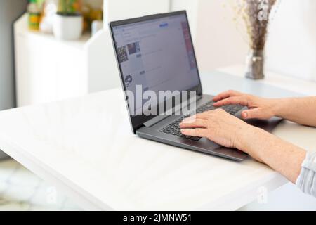 Old woman hands using computer Stock Photo