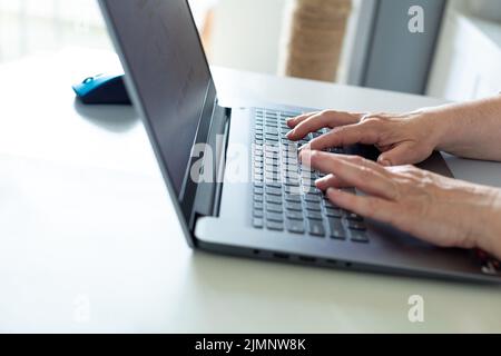 Old woman hands using computer Stock Photo