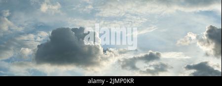 grey clouds against a pale blue sky at sunset Stock Photo
