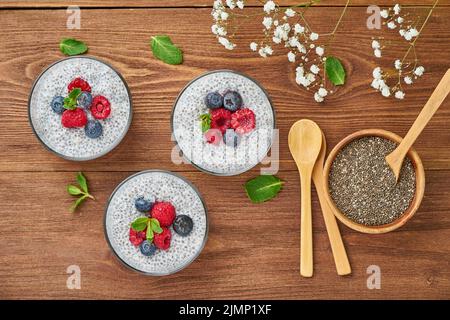 Banner with Chia pudding in bowl with fresh berries raspberries, blueberries. Stock Photo