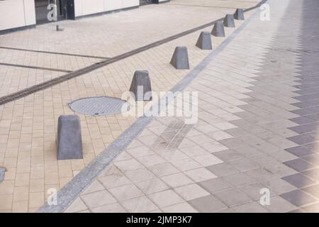 Pavement repair and laying of paving slabs on the walkway, stacked tile cubes on the background. Laying paving slabs in the pedestrian zone of the Stock Photo