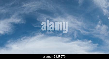 Soft wispy cloud formation against blue sky Stock Photo