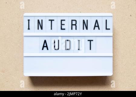 Lightbox with word internal audit on wood background Stock Photo
