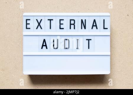 Lightbox with word external audit on wood background Stock Photo