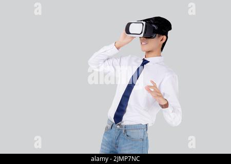 Experience of young asian businessman wearing VR Headset with excited isolated on white background, metaverse or virtual reality tech, innovation of f Stock Photo