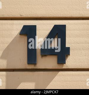 House number 14 on the facade of a house in Magdeburg in Germany Stock Photo