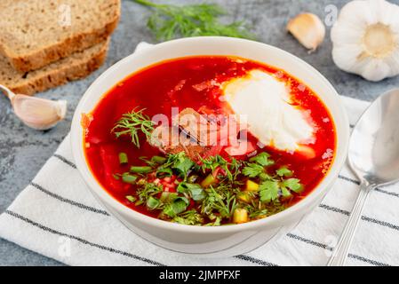 Traditional Russian or Ukrainian soup borscht with sour cream Stock Photo