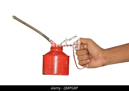 Old Hand holding a red oil can Stock Photo