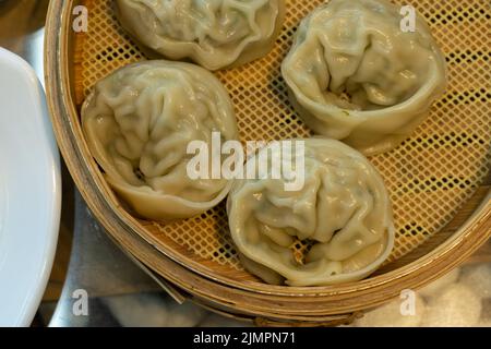steamed dumplings in a bamboo steaming basket. Stock Photo