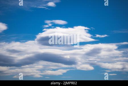 Fluffy white cloud on blue sky in daylight Stock Photo