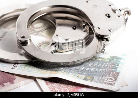 Croatian kuna currency. Police handcuffs on Croatian kuna banknotes. Currency exchange, concept of economic crime in Europe. Stock Photo