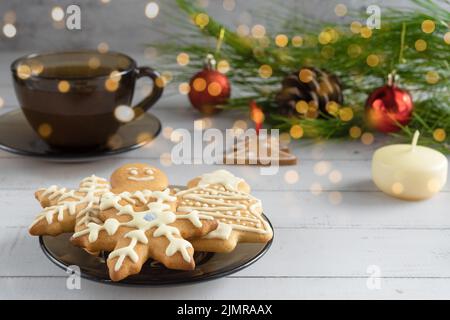 Christmas background. Gingerbread cookies, tea, Christmas tree branches, Christmas toys and candles. Stock Photo