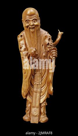 Wood statue of japan lucky god, God of prolonging life longevity Fukurokuju isolated on black background Stock Photo