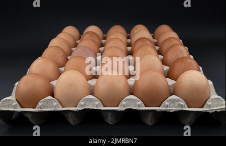 Brown eggs, 30 pieces, in a carton. Stock Photo