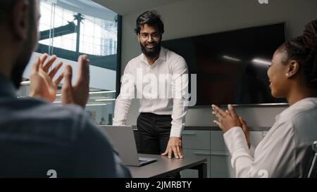 Arab indian bearded businessman mentor boss male leader man report share idea startup project presentation corporate training to investors applauding Stock Photo