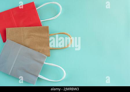 Empty paper shopping bags isolated on blue background Stock Photo