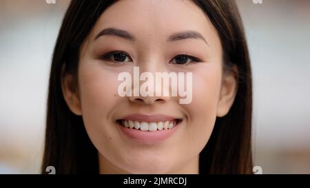 Female portrait close up face happy excited successful satisfied girl with natural makeup asian korean woman lady client dentistry service dentist Stock Photo