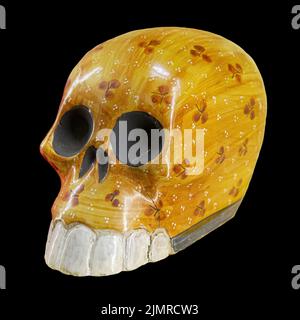 Typical Mexican skull painted isolated on black background. Dia de los muertos. Creative and minimal Day of the Dead or Hallowee Stock Photo