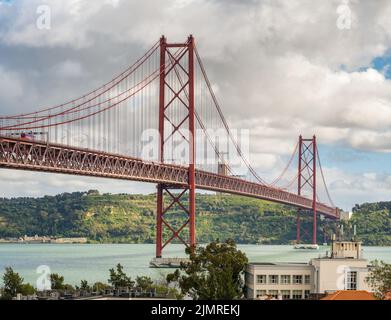 Famous 25 de Abril Bridge in Lisbon, Portugal. Stock Photo