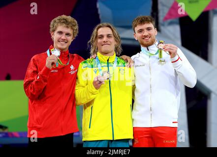 Australia's Cassiel Emmanuel Rousseau (centre) celebrates with his gold medal alongside Canada's Rylan Mackenzie Wiens (left) who finished second to take silver and England's Matthew Lee (right) who took bronze in the Men's 10m Platform Diving Final at Sandwell Aquatics Centre on day ten of the 2022 Commonwealth Games in Birmingham. Picture date: Sunday August 7, 2022. Stock Photo