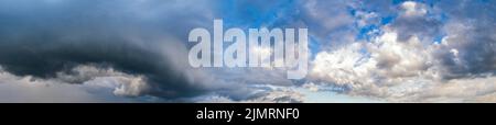 Dramatic cloudy sky with circular thunderstorm cloud. Natural weather and climate sky panoramic background scene. Stock Photo