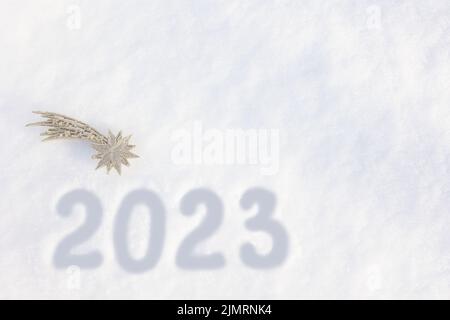 Text Happy New Year 2023 on the snow. Handwritten inscription 2023 Abstract background photo of upcoming New Year 2023 Stock Photo