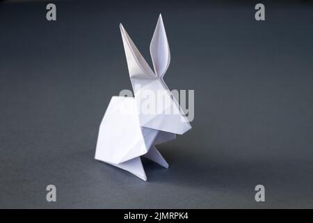 White paper rabbit origami isolated on a grey background Stock Photo