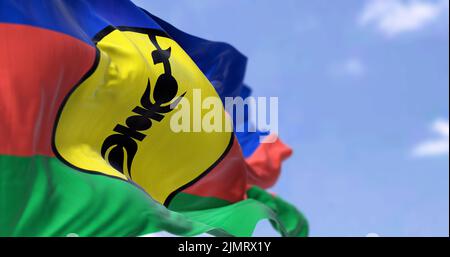 The flag of New Caledonia waving in the wind on a clear day Stock Photo