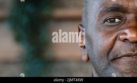 Close up detail half face human sad eyesight male portrait african american adult mature grandpa senior man businessman ethnic healthy patient of Stock Photo