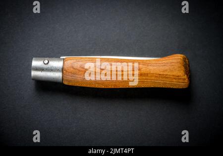 Traditional wooden pocket knife on black background Stock Photo