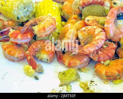 Close up of cooked shrimp, corn on the cob, and potatoes Stock Photo