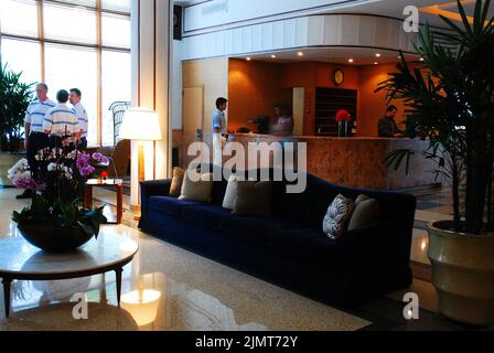 Guests wait near the front desk of the chic Art Deco Raleigh Hotel in Miami Beach, Florida Stock Photo