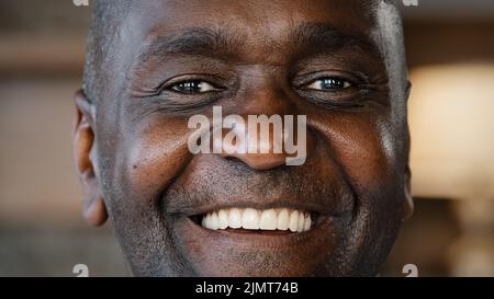 Close up happy male face portrait 60s african american man senior grandfather adult friendly person elderly ethnic pensioner looks at camera posing Stock Photo