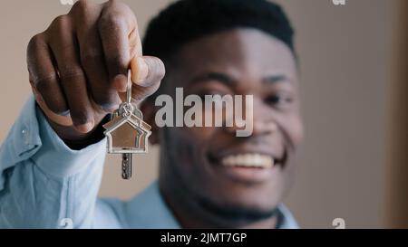 Overjoyed young african american male happy homeowner realtor win apartment in lottery excited young man own flat buyer real estate agent showing bunc Stock Photo