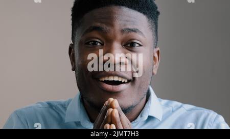 Shocked happy african american young boyfriend business man surprised look at camera rejoice good news amazed guy joyful male winner show wow reaction Stock Photo
