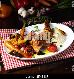 Rustic fried chicken legs with assorted vegetables and rice Stock Photo