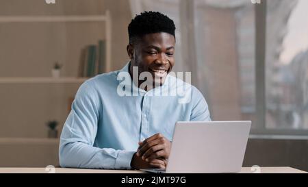 African american businessman young professional worker educator teacher millennial smiling guy talk video call on computer look at webcam online chat Stock Photo